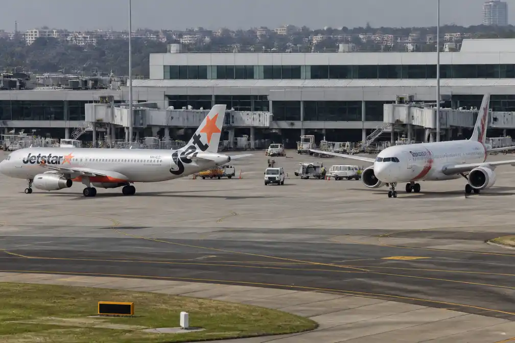 Twee vliegtuigen ontwijken botsing op Sydney Airport, bemanningslid gewond